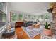 Light-filled sunroom with hardwood floors, large windows, and a charming decor, creating a cozy atmosphere at 109 Lakeview Dr, Summerville, SC 29485