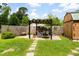Charming backyard with pergola, quaint shed, and a well-maintained lawn at 109 Rahway Rd, Goose Creek, SC 29445