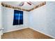 Comfortable bedroom with patterned walls, window with blue curtains, and ample natural light at 109 Rahway Rd, Goose Creek, SC 29445