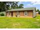 Quaint brick home with green roof, surrounded by lush landscaping at 109 Rahway Rd, Goose Creek, SC 29445