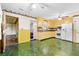Eat-in kitchen featuring yellow cabinetry, white appliances, and vintage decor in spacious layout at 109 Rahway Rd, Goose Creek, SC 29445