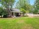 Large backyard featuring a covered patio, mature trees, and a fenced perimeter at 113 Mapperton Ct, Summerville, SC 29485