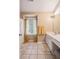 Bright bathroom featuring double sinks, tile flooring, and a window at 113 Mapperton Ct, Summerville, SC 29485