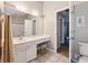 Clean and tidy bathroom with white cabinets, large mirror, and neutral paint at 113 Mapperton Ct, Summerville, SC 29485