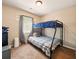 A cozy bedroom features a bunk bed with blue bedding and a window for natural light at 113 Mapperton Ct, Summerville, SC 29485