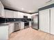 A bright kitchen with white cabinets, stainless steel appliances, and tile flooring at 113 Mapperton Ct, Summerville, SC 29485