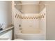 Bathroom with a white tub and shower combination, white tile and a large, grey vanity at 130 River Landing Dr # 2310, Daniel Island, SC 29492