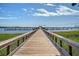 Scenic wooden boardwalk leading to a marina with boats docked on a sunny day at 130 River Landing Dr # 2310, Daniel Island, SC 29492