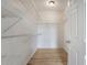 Walk-in closet with white wire shelving and wood-look floors at 130 River Landing Dr # 2310, Daniel Island, SC 29492