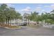 Beautiful condo complex with meticulously maintained landscaping, palm trees, and ample parking at 130 River Landing Dr # 2310, Daniel Island, SC 29492