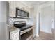 This modern kitchen features stainless steel appliances, granite countertops, and stylish backsplash at 130 River Landing Dr # 2310, Daniel Island, SC 29492