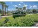 Entrance to Waterfront Park on Daniel Island, featuring lush greenery, palm trees, and nearby buildings at 130 River Landing Dr # 2310, Daniel Island, SC 29492