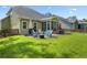Expansive backyard with outdoor seating, grill, lush lawn, and views of neighboring homes at 132 Daniels Ridge Dr, Summerville, SC 29485