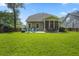 Spacious backyard with lush green grass, patio, and outdoor seating area for entertaining at 132 Daniels Ridge Dr, Summerville, SC 29485