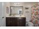 Well-lit bathroom features a vanity with a mirror, toilet, and shower with a patterned curtain at 132 Daniels Ridge Dr, Summerville, SC 29485
