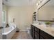 Bright bathroom features a double sink vanity, soaking tub, and neutral tile, providing a clean and functional space at 132 Daniels Ridge Dr, Summerville, SC 29485
