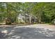 Community clubhouse nestled among trees, with well-maintained landscaping and parking, next to a playground at 132 Daniels Ridge Dr, Summerville, SC 29485