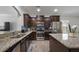 Well-equipped kitchen with stainless steel appliances, granite countertops, and dark wood cabinetry at 132 Daniels Ridge Dr, Summerville, SC 29485