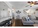 Open-concept living area with hardwood floors, a breakfast bar, gray sectional sofa, and ample natural light at 132 Daniels Ridge Dr, Summerville, SC 29485