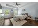 Comfortable main bedroom boasts hardwood floors, tray ceiling, and sun-filled windows for a bright, inviting atmosphere at 132 Daniels Ridge Dr, Summerville, SC 29485