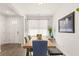 Bright dining room features hardwood floors, natural light, and table that sits six people comfortably at 132 Wild Holly Dr, Moncks Corner, SC 29461