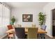 Dining room with hardwood floors, modern art, and table that sits six people comfortably at 132 Wild Holly Dr, Moncks Corner, SC 29461