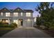 Charming two-story home with gray siding, attached garage, well-manicured lawn and blooming bushes in front at 132 Wild Holly Dr, Moncks Corner, SC 29461