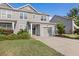 Charming townhouse with manicured landscaping, a garage, and a welcoming entrance at 132 Wild Holly Dr, Moncks Corner, SC 29461