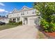 A well-maintained townhouse with an attached garage and manicured yard at 132 Wild Holly Dr, Moncks Corner, SC 29461