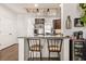 Entertainer's kitchen with granite countertops, bar seating, and a custom glass rack at 132 Wild Holly Dr, Moncks Corner, SC 29461