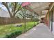 Expansive backyard with a covered patio, lush green grass, privacy fence, and a fire pit at 1549 N Avalon Cir, Charleston, SC 29407