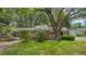 Charming brick home featuring a well-manicured lawn and mature trees for shade at 1549 N Avalon Cir, Charleston, SC 29407