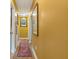 Long hallway featuring vintage rug on hardwood flooring and golden colored walls at 1549 N Avalon Cir, Charleston, SC 29407