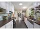 Stylish kitchen featuring white cabinets, dark countertops, and stainless-steel appliances at 1549 N Avalon Cir, Charleston, SC 29407