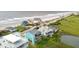Stunning aerial view of colorful beach houses, showcasing the coastal charm and neighborhood at 1568 E Ashley Ave, Folly Beach, SC 29439