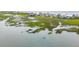 Scenic aerial view of waterfront community with docks and lush green marshlands at 1568 E Ashley Ave, Folly Beach, SC 29439
