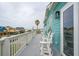 Relaxing balcony with white chairs and stunning views of the neighborhood at 1568 E Ashley Ave, Folly Beach, SC 29439
