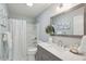 Stylish bathroom with a gray vanity, a white marble countertop, and a modern mirror, blending elegance and functionality at 1568 E Ashley Ave, Folly Beach, SC 29439