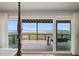 Bedroom view showing sliding glass doors to the porch with water view and a cozy porch swing at 1568 E Ashley Ave, Folly Beach, SC 29439