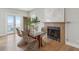 Inviting dining room boasts a glass-top table, unique wicker chairs, fireplace, and scenic ocean views at 1568 E Ashley Ave, Folly Beach, SC 29439