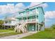 Inviting two-story beach house with multiple balconies, offering ample outdoor living space at 1568 E Ashley Ave, Folly Beach, SC 29439