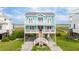 Two-story coastal home featuring a blue exterior, white railings, and a welcoming stairway at 1568 E Ashley Ave, Folly Beach, SC 29439