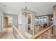 Bright hallway featuring modern railing, hardwood floors, a geometric light fixture and water views at 1568 E Ashley Ave, Folly Beach, SC 29439