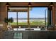 Wet bar featuring a built-in wine cooler, granite counters, wood accents, and view at 1568 E Ashley Ave, Folly Beach, SC 29439