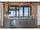 Wet bar featuring a built-in wine cooler, granite counters, wood accents, and view at 1568 E Ashley Ave, Folly Beach, SC 29439