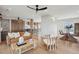 Bright living room with leather sofa, ceiling fan, and wood flooring, and open access to the modern kitchen at 1568 E Ashley Ave, Folly Beach, SC 29439