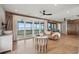 Charming living room with a brown leather sofa, wood accents, deck access through sliding glass doors, and modern furnishings at 1568 E Ashley Ave, Folly Beach, SC 29439