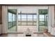 Relaxing screened porch with ceiling fans and panoramic views of the marsh, accessible through sliding glass doors at 1568 E Ashley Ave, Folly Beach, SC 29439