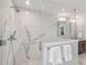 Bathroom shower featuring glass door, marble tiling with striking gray veins, and chrome shower fixtures at 1568 E Ashley Ave, Folly Beach, SC 29439