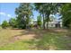 Backyard with green grass, trees, fence, and play structure at 1578 Stanwick Dr, Johns Island, SC 29455